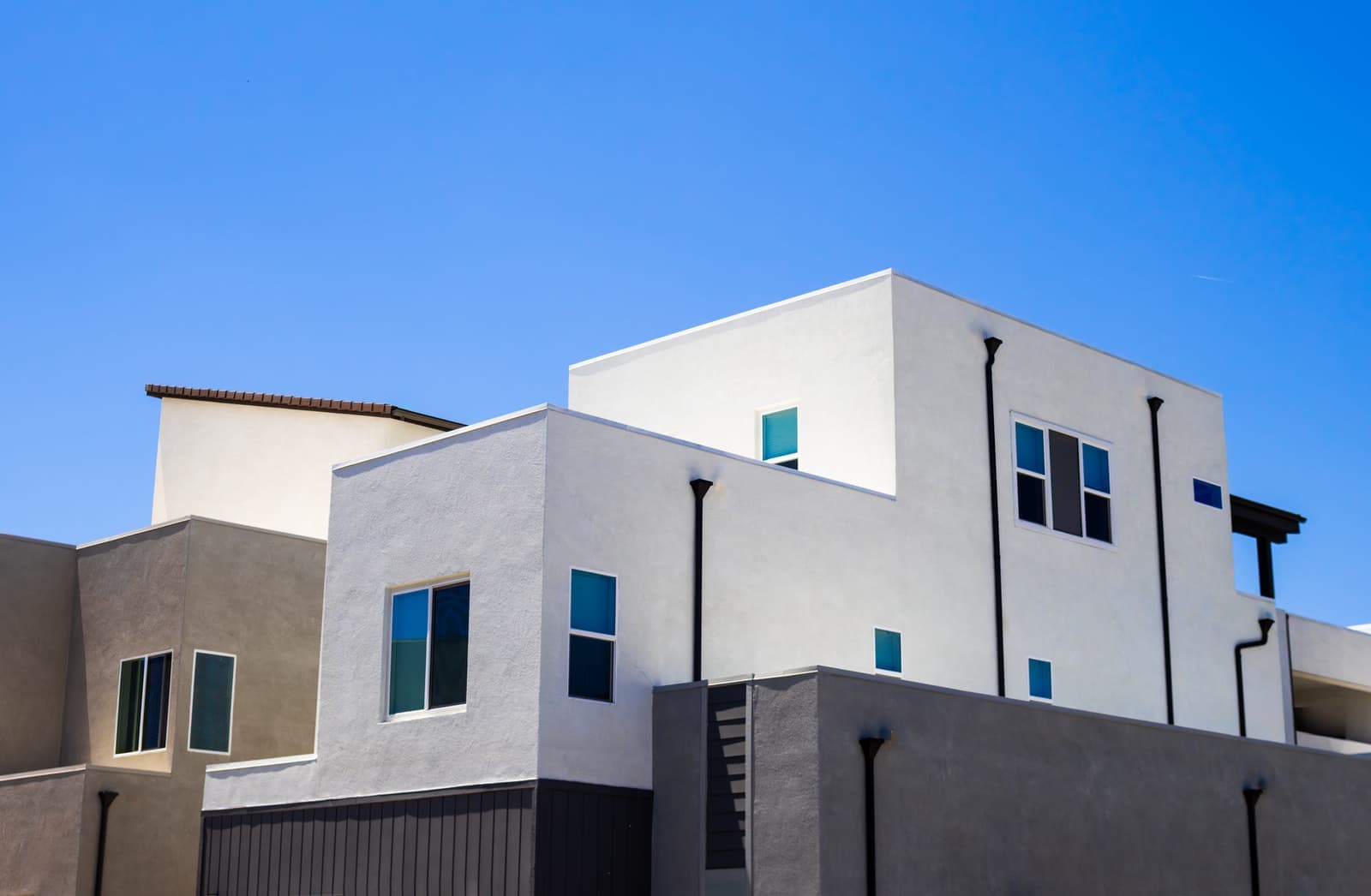 White stucco modern houses against blue sky