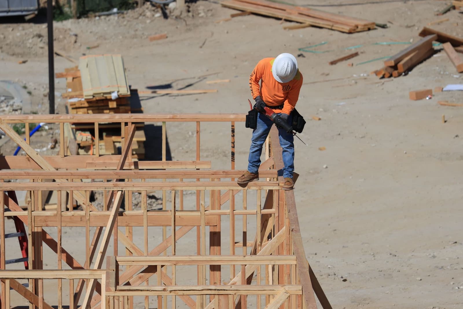 Framer walking on wood wall framing