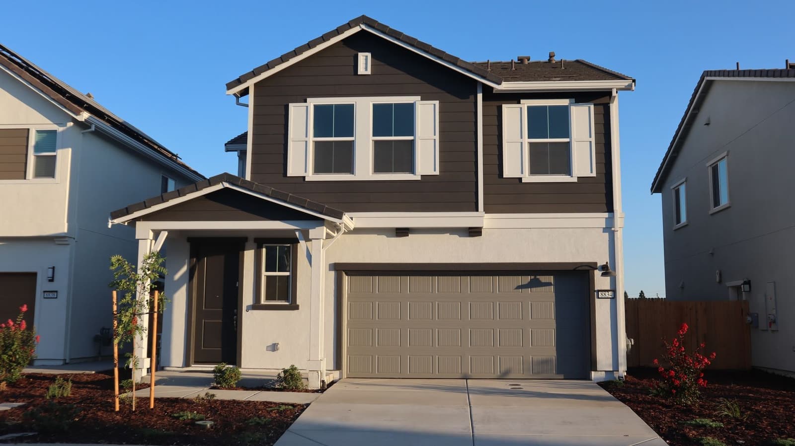 Two-story house with dark shingle roof