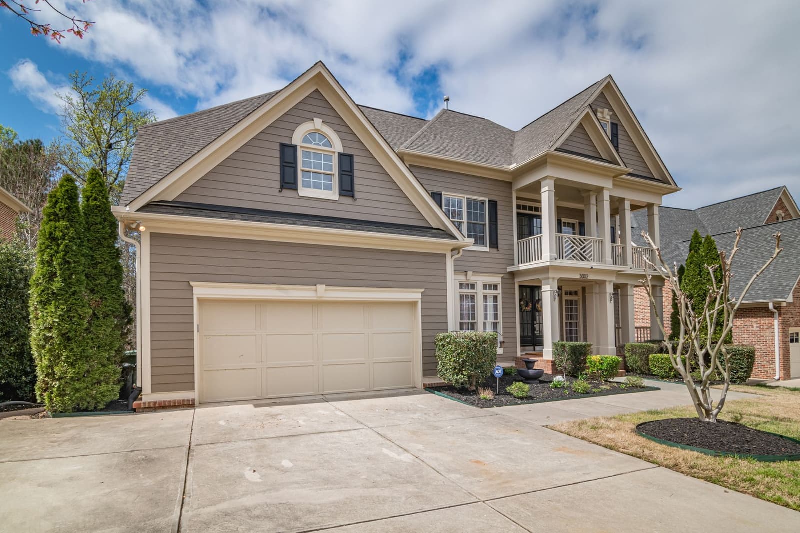 Large home with shingle roof and driveway