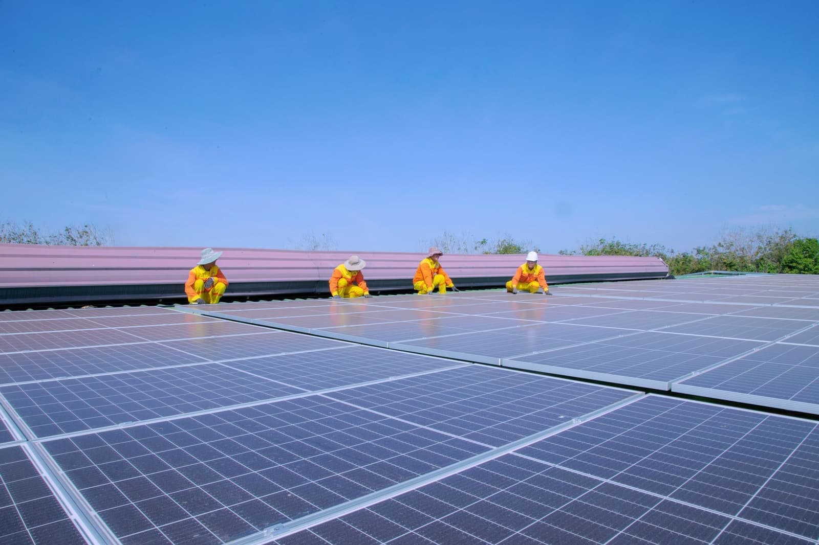 Crew installing solar panels on a commercial roof