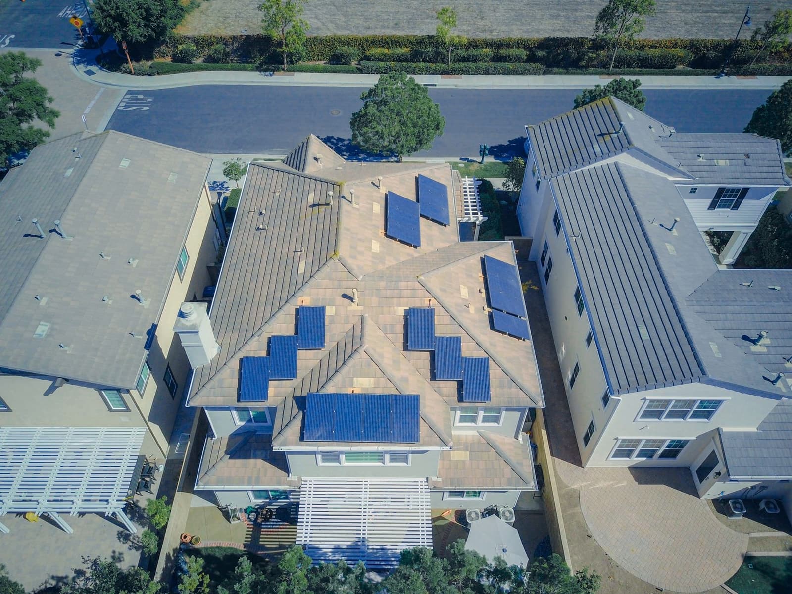 Aerial view of tile roof house with solar panels
