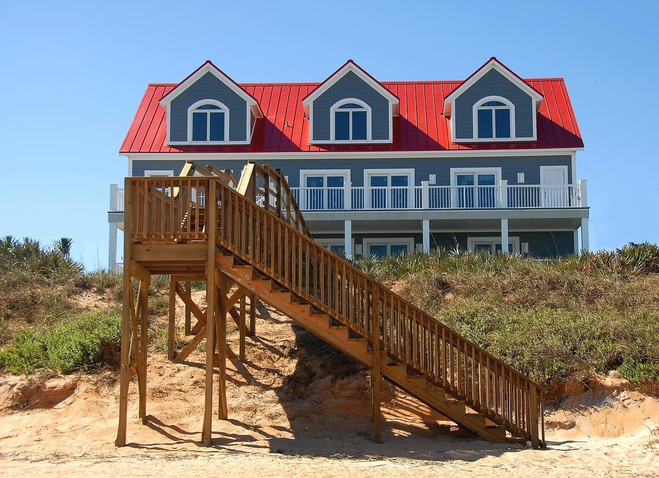 House with red metal roof and dormers